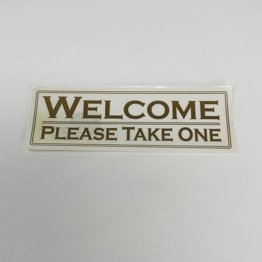 Sticker Welcome Please Take One white with gold letters  2"x 6"  (SGWEL)